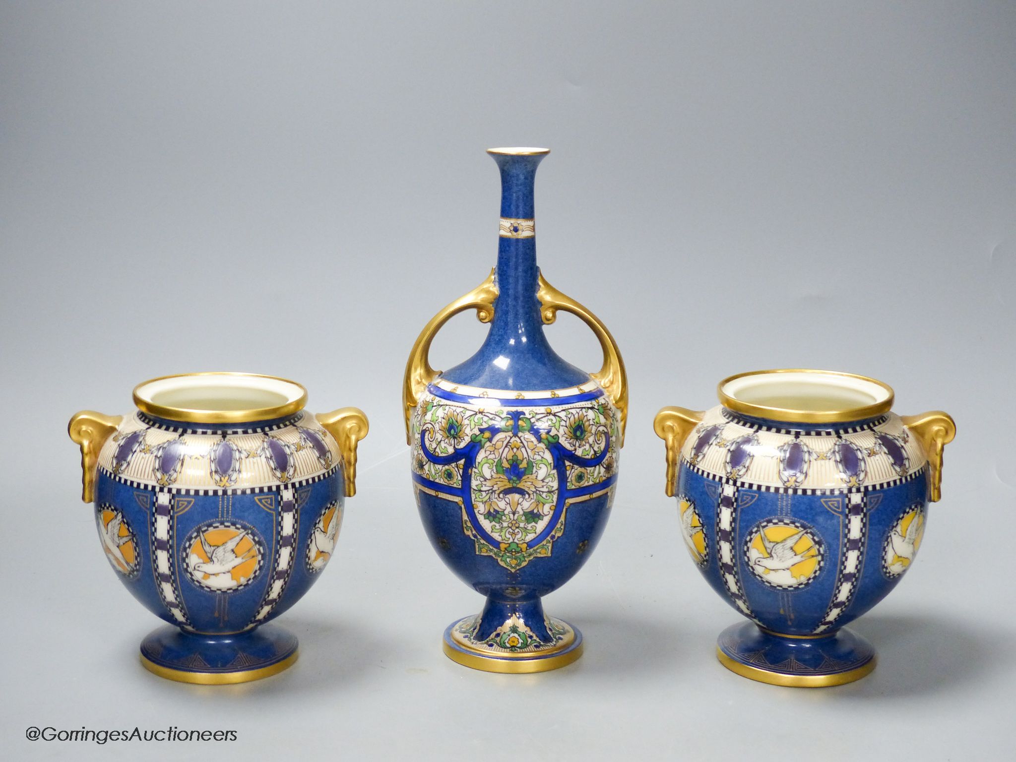 A pair of Royal Worcester powder blue vases and another similar vase, height 23cm